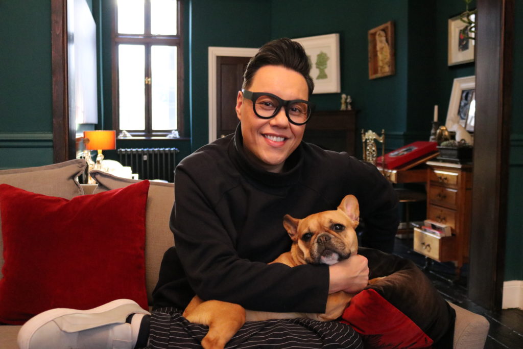 Gay TV presenter Gok Wan at home with his dog