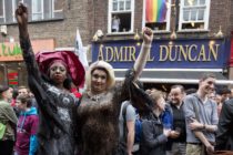 Photo of people gathering outside the Admiral Duncan pub in Old Compton Street in the Soho, which was attacked with a nail bomb on April 30, 1999, to remember the victims of the Orlando massacre, on June 13, 2016.
