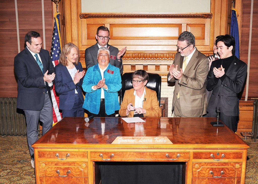 Governor of Kansas Laura Kelly signs an executive order protecting LGBT+ state employees from discrimination