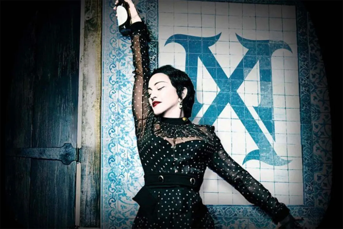 Madonna as Madame X, standing against a wall