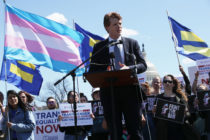 Joe Kennedy at a rally with the White House just behind