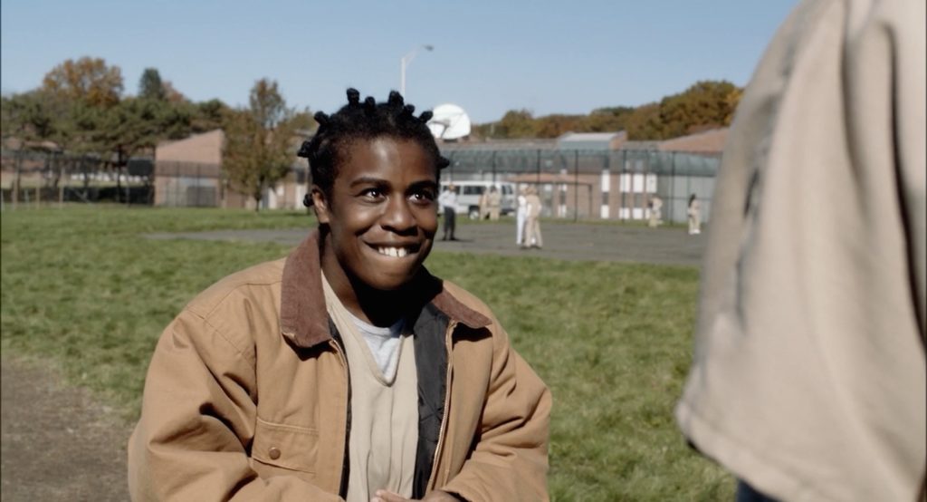 Crazy Eyes tells Piper her poem in the yard (Netflix/Orange Is the New Black)