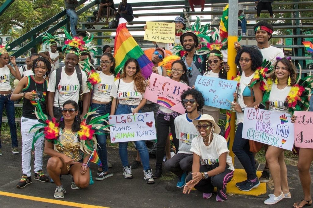 LGBT+ right activists at Guyana Pride holding up signs