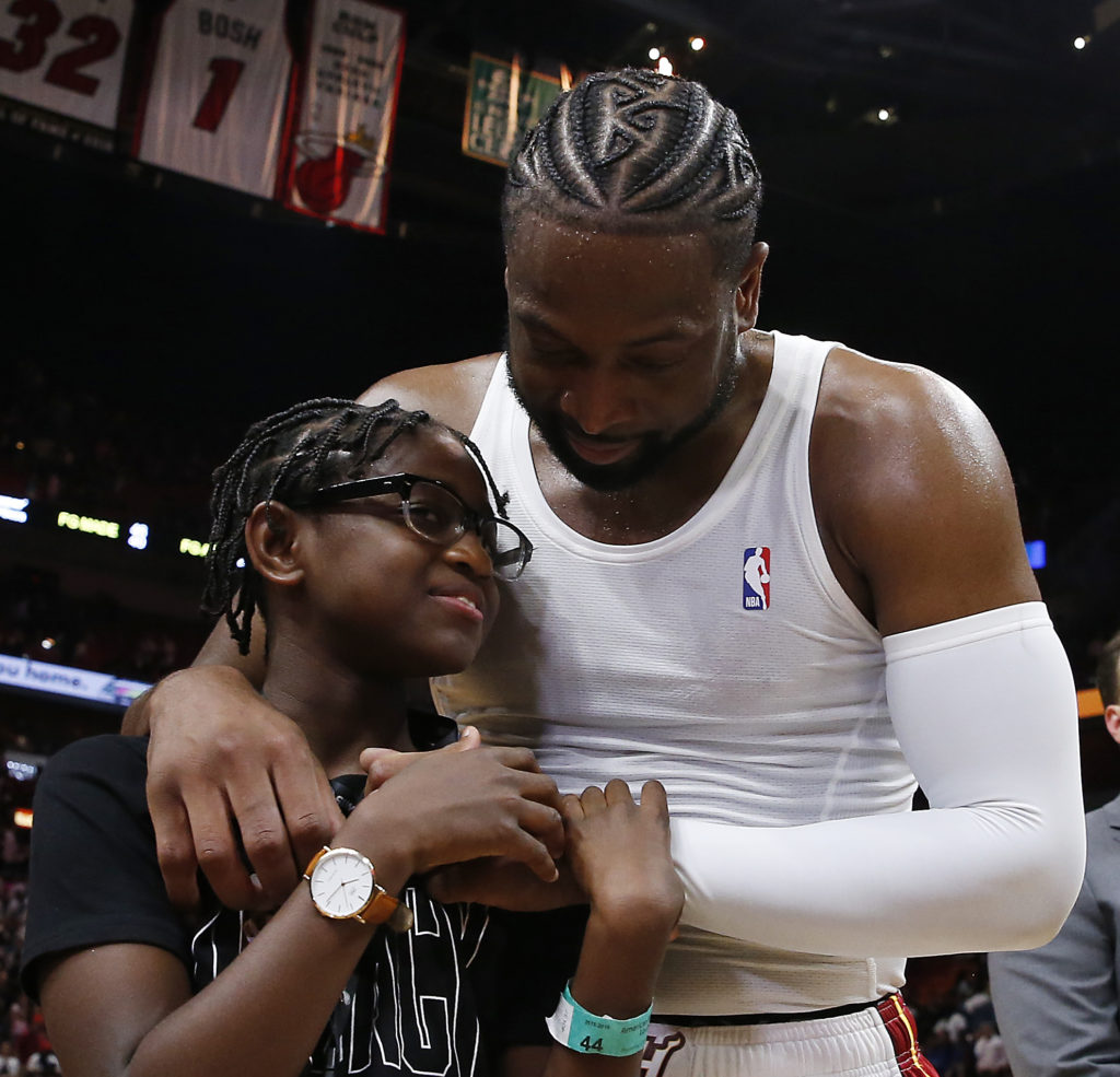 Dwyane Wade hugs his son Zion