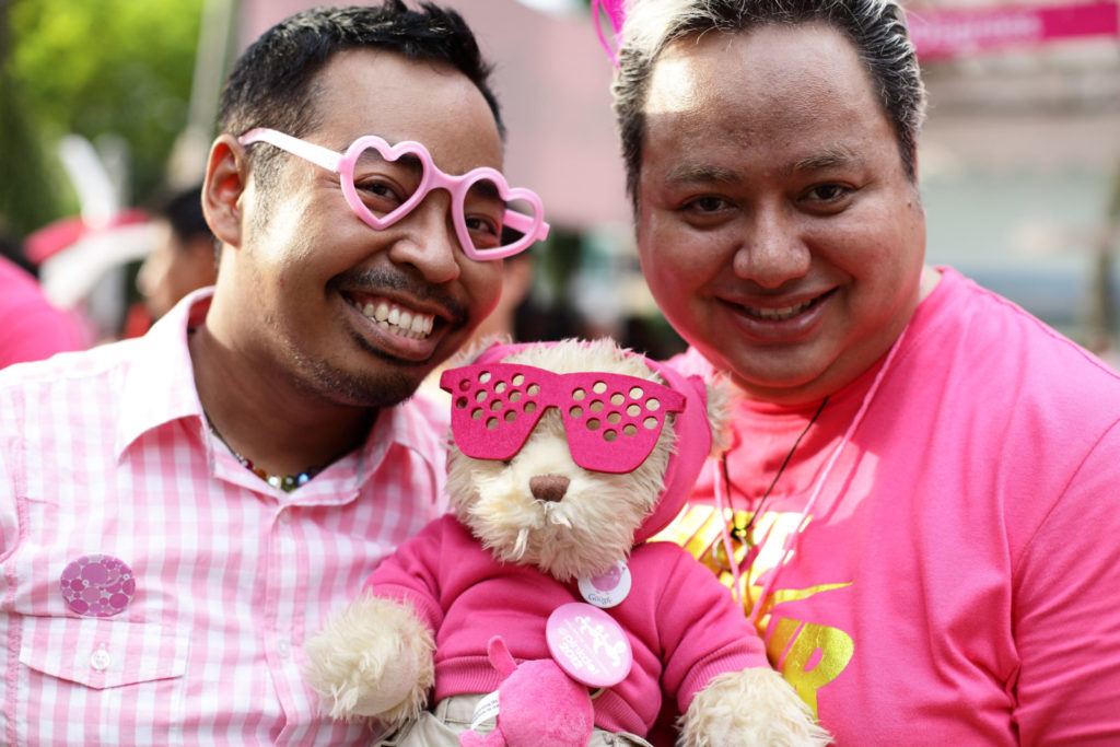 SINGAPORE - JUNE 30: Participants dress in various shades of pink pose for a photo during the 'Night Pink Dot' event arrange to increase awareness and understanding of the lesbian, gay, bisexual and transgender community in Singapore at Hong Lim Park on June 30, 2012 in Singapore. The event is the fourth annual gathering held in support of the freedom to love. (Photo by Suhaimi Abdullah/Getty Images)