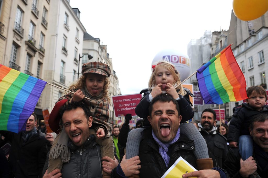 PARIS, FRANCE - DECEMBER 16: People demonstrate for the legalisation of gay marriage and parenting on December 16, 2012 in Paris, France. Demonstrations have shown a deep division in French society over the marriage equality bill expected to be passed in early 2013. The bill would not only legalize same-sex marriage but would also allow gay couples to adopt, which is seen as the most controversial issue. French President Francois Hollande, who has supported the legislation, is facing criticism from anti-gay and religious groups, while gay rights groups have warned of inadequacies within the bill. (Photo by Antoine Antoniol/Getty Images)