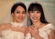 Japanese actress Akane Sugimori (R) and her partner Ayaka Ichinose, both dressed in white, display their wedding rings at a press conference after their marriage ceremony in Tokyo on April 19, 2015. The lesbian couple held a symbolic wedding ceremony in Tokyo, as calls grow for Japan to legalise same-sex marriage. While their marriage will not be recognised under law, actresses Ichinose, 34, and Sugimori, 28 tied the knot in front of some 80 relatives and friends. AFP PHOTO / Yoshikazu TSUNO (Photo credit should read YOSHIKAZU TSUNO/AFP/Getty Images)