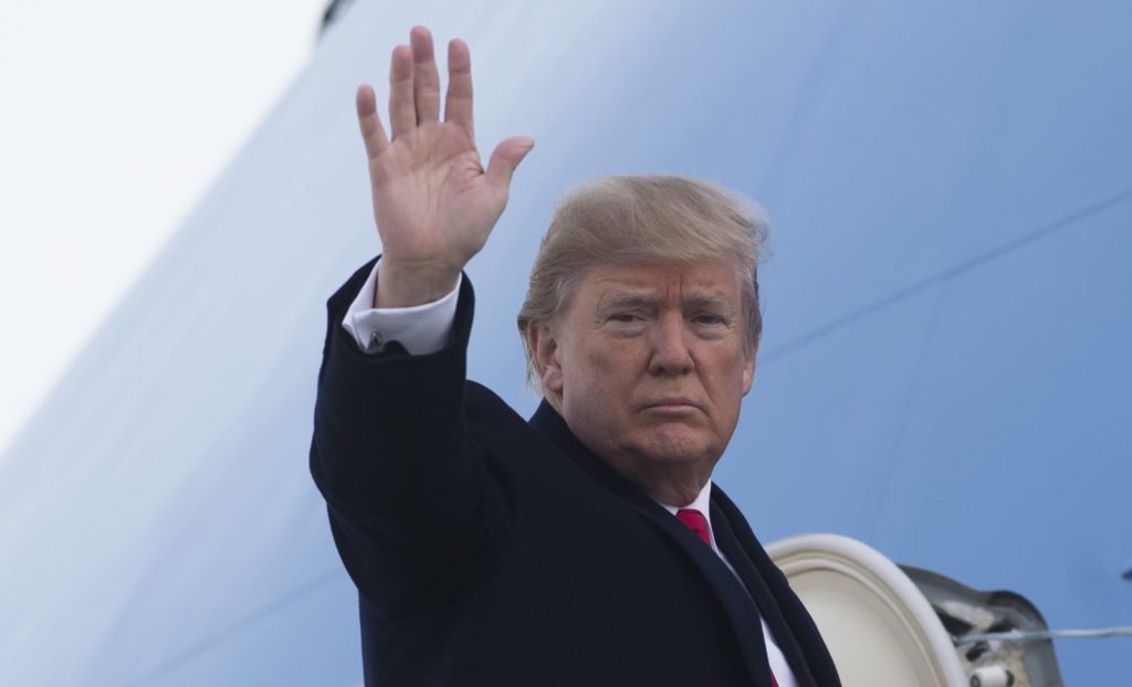US President Donald Trump waves from Air Force One prior to departure from Andrews Air Force Base in Maryland, December 4, 2017, as Trump travels to Salt Lake City, Utah. / AFP PHOTO / SAUL LOEB (Photo credit should read SAUL LOEB/AFP/Getty Images)