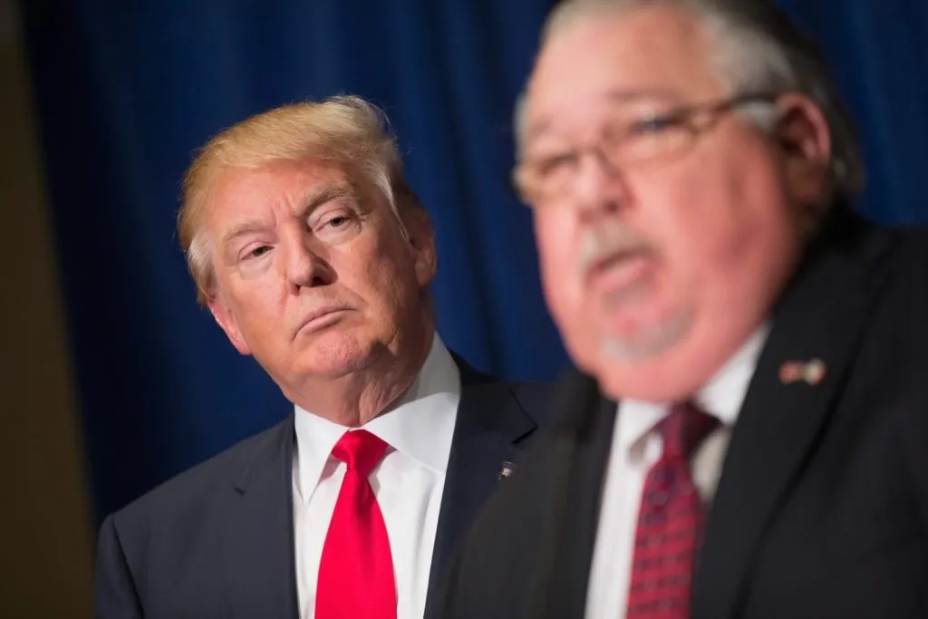 DUBUQUE, IA - AUGUST 25: Republican presidential candidate Donald Trump (L) listens as Sam Clovis speaks at a press conference at the Grand River Center on August 25, 2015 in Dubuque, Iowa. Clovis recently quit his position as Iowa campaign chairman for Rick Perry. Trump leads most polls in the race for the Republican presidential nomination. (Photo by Scott Olson/Getty Images)