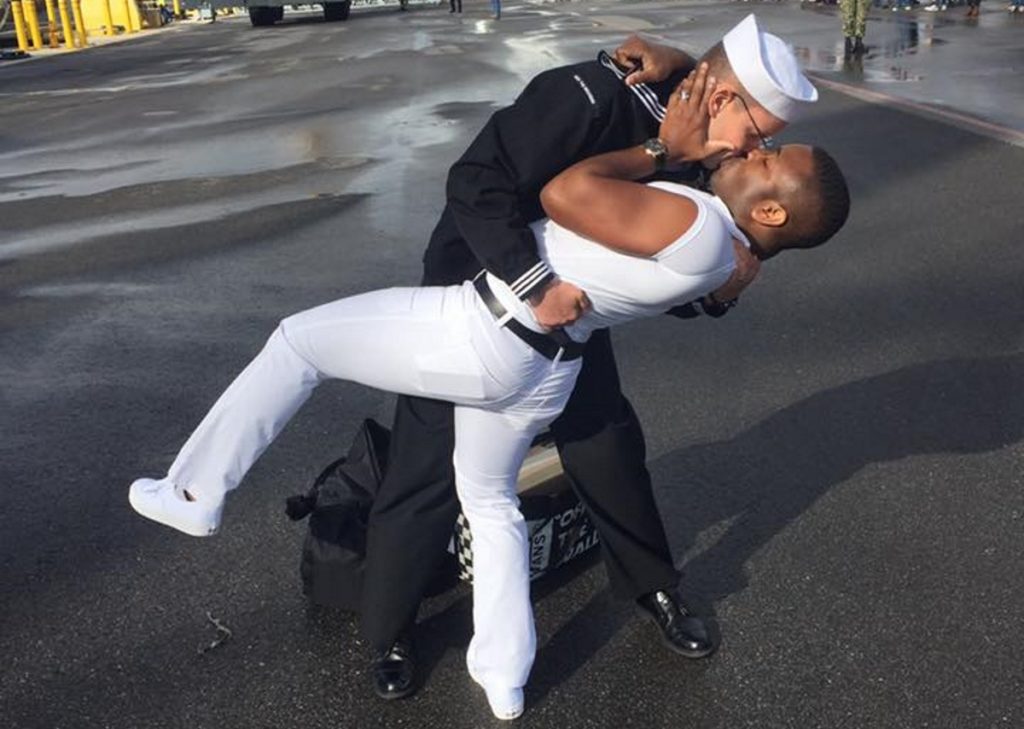 Bryan Woodington and Kenneth Woodington kissing after Bryan gets back from seven months in the Middle East on the USS The Sullivans