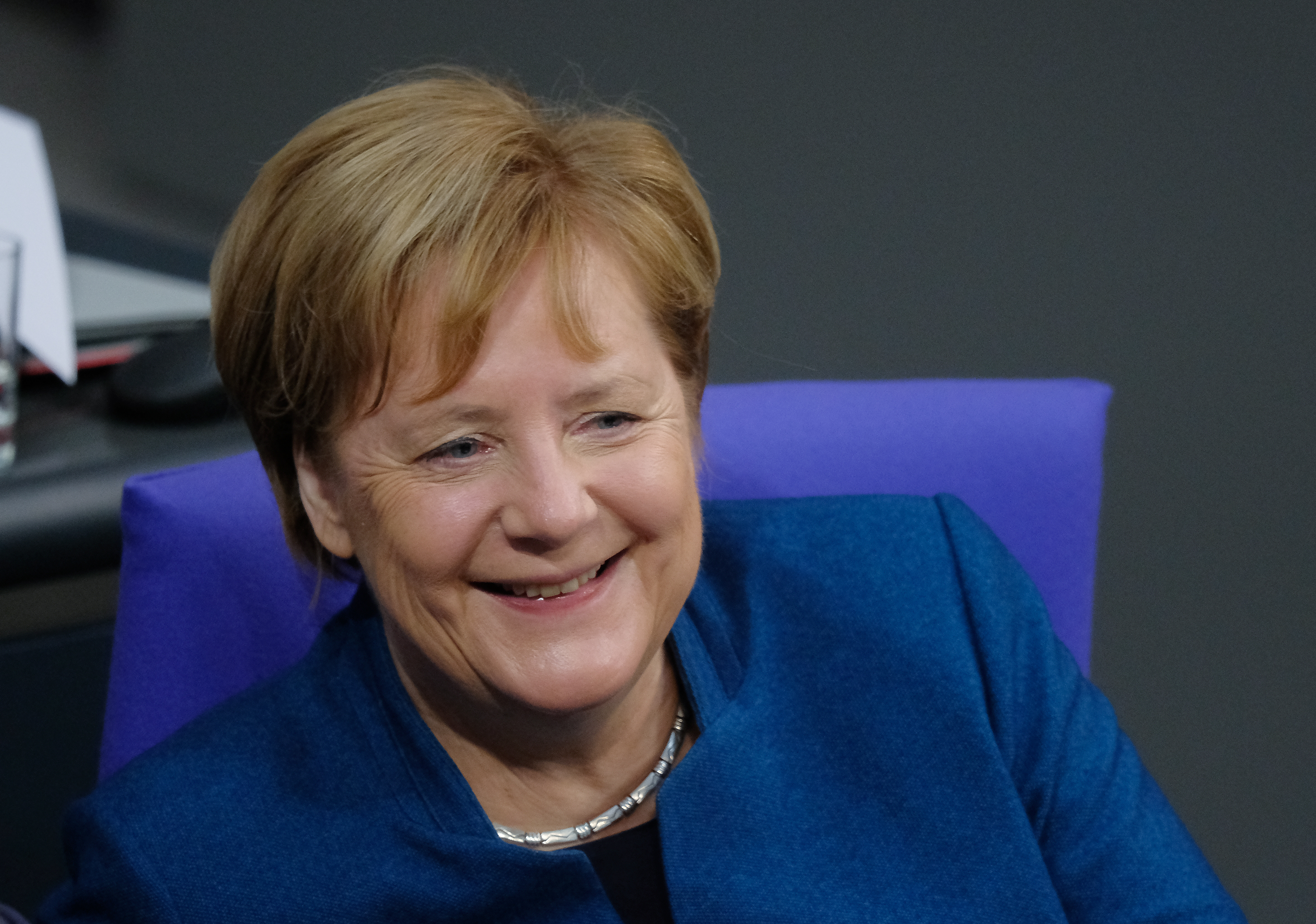 German Chancellor Angela Merkel sits down at the Bundestag