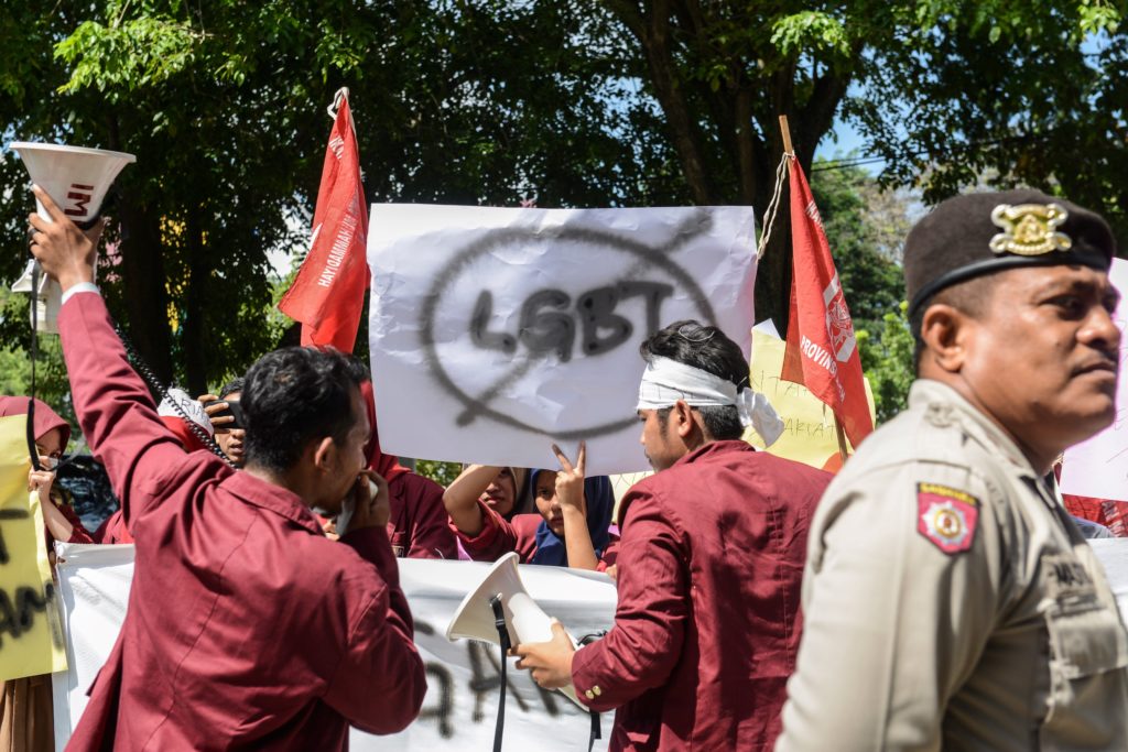 A group of Muslim protesters march with banners against the LGBT community in Banda Aceh on Decmber 27, 2017