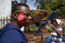A Ugandan man with a sticker on his face takes part on August 9, 2014 in the annual gay pride in Entebbe, Uganda