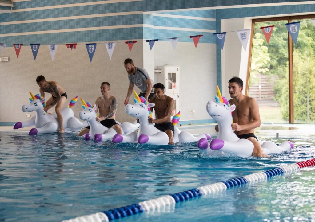 The England team riding inflatable unicorns.