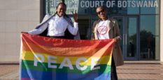 Activists pose with a rainbow flag as they celebrate outside Botswana High Court in Gaborone on June 11, 2019.