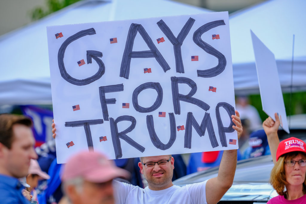 LGB Republican holds banner that reads 'Gays for Trump'