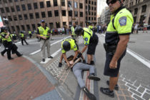 Boston Police officers arrest an anti-parade demonstrator during the "Straight Pride" parade in Boston, on August 31, 2019.