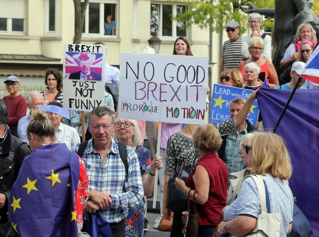 Protestors hold placards as they look on outside the venue for talks between the British Prime Minister and EU Commission president in Luxembourg. (FRANCOIS WALSCHAERTS/AFP/Getty Images)