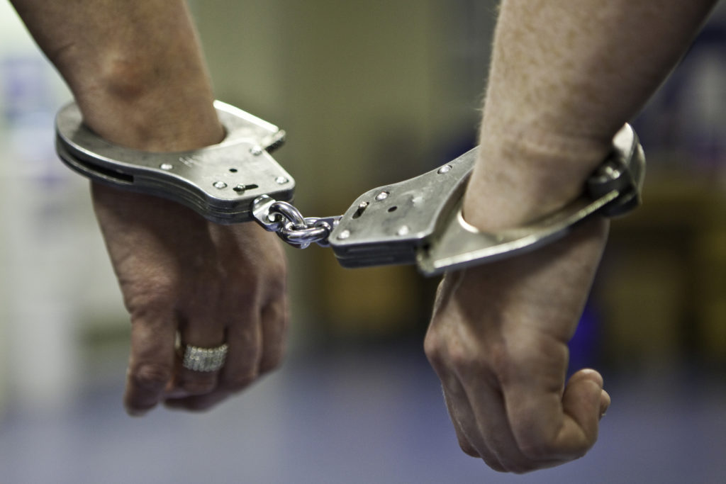 A prisoner's hands in handcuffs
