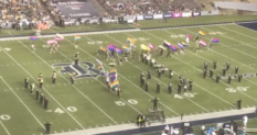 Marching band members at Rice University take to the stadium field raising and waving Pride flags. (Screen capture via Twitter/@ricemob)