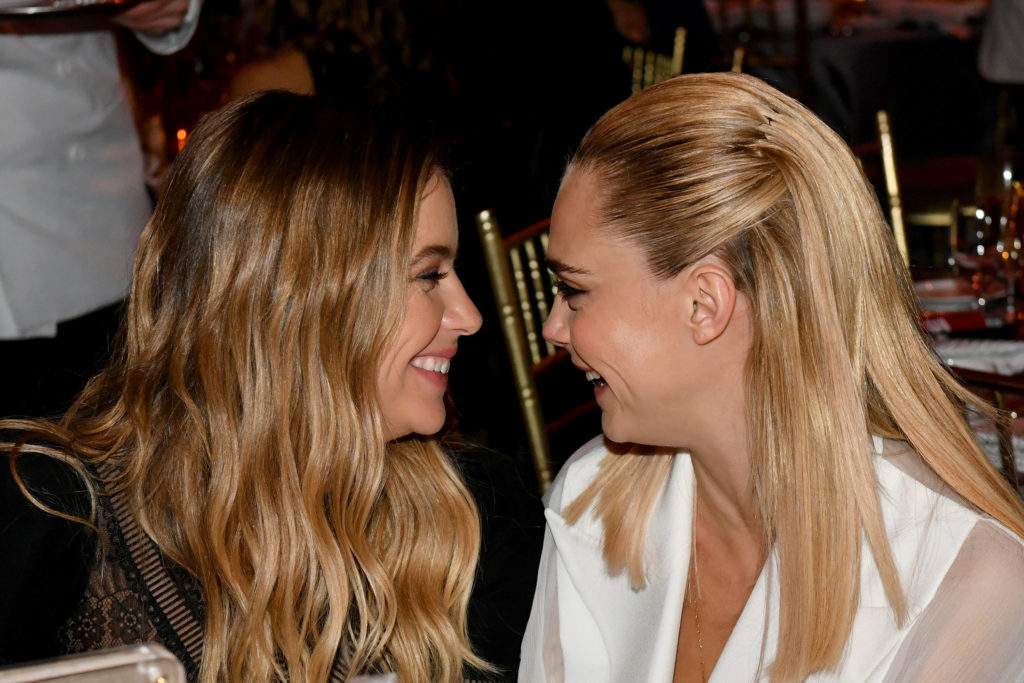 Ashley Benson and Cara Delevingne smiling at each other