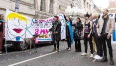 Members of LGBTQ community stage a 'marriage' between three men and a dog during a protest against Boris Johnson