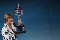 Former Australian tennis player Margaret Court poses with a replica of the trophy to commemorate 50 years of her Australian grand slam win