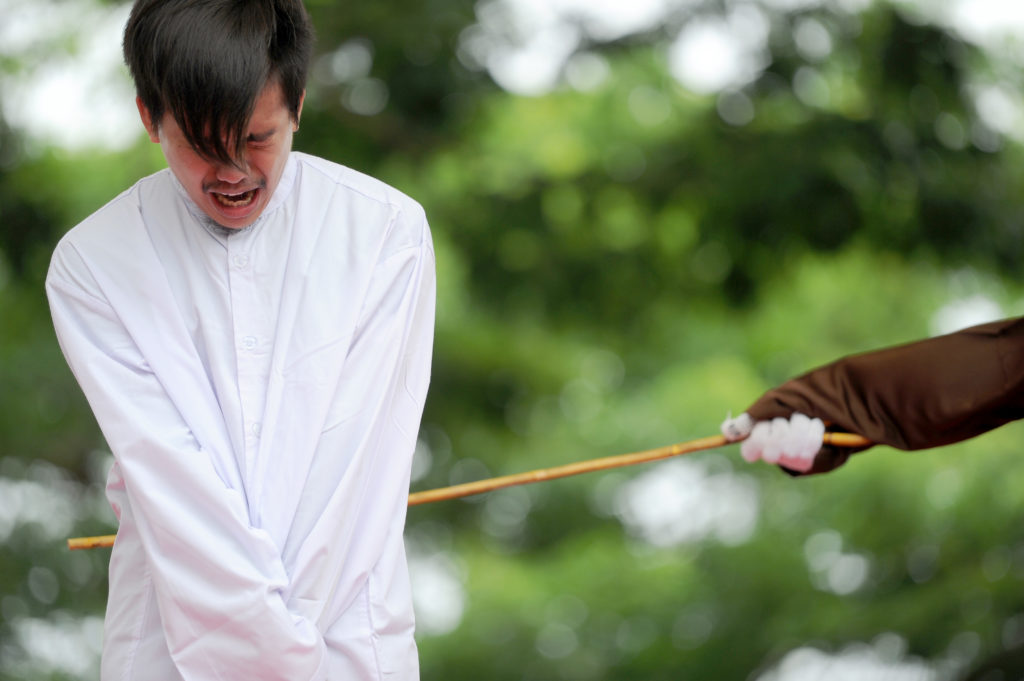 One of two Indonesian men is publicly caned for having sex, in a first for the Muslim-majority country where there are concerns over mounting hostility towards the small gay community, in Banda Aceh on May 23, 2017. (CHAIDEER MAHYUDDIN/AFP via Getty Images)