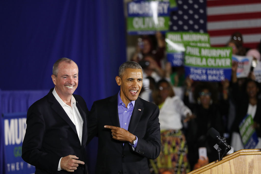 Former US President Barack Obama stands on stage with Democratic gubernatorial candidate Phil Murphy on October 19, 2017 in Newark, New Jersey