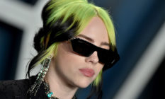 Billie Eilish with green hair and sunglasses