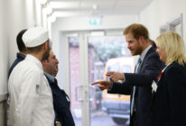 Prince Harry meets catering staff during his visit to Mildmay hospital, a dedicated HIV hospital. (Yui Mok-WPA Pool/Getty Images)