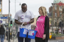 Shaking their donation buckers full of loose change with a smile, volunteers are vital for Cancer Research UK. (Cancer Research UK)