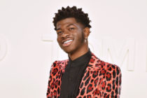 Lil Nas X in an orange leopard print suit