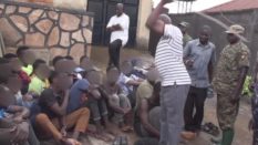 Around 23 LGBT+ people in Uganda were whipped by officials before being chained and walked to the police station, disturbing footage shows. (Screen capture via YouTube)