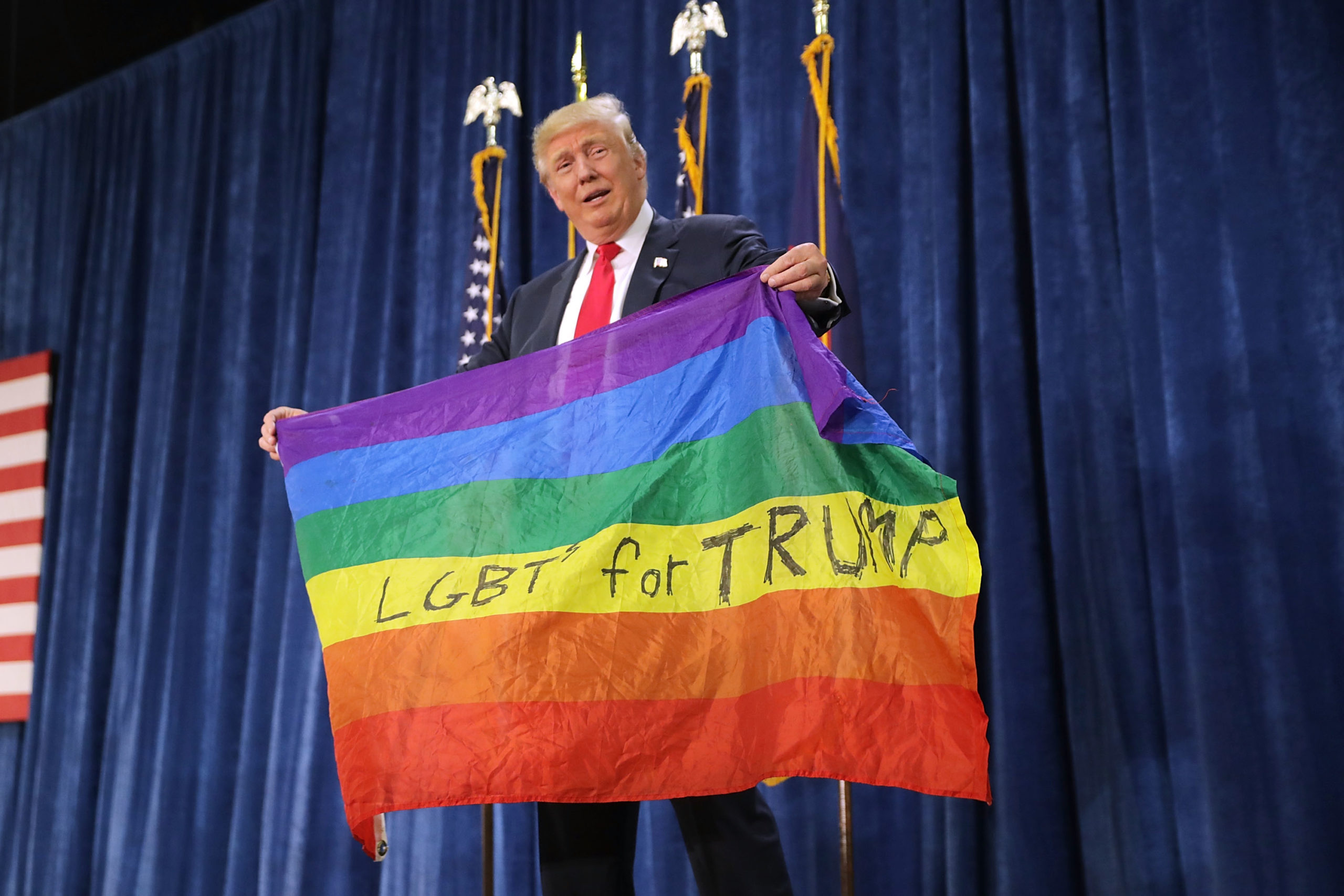 Donald Trump holds an LGBT+ Pride flag