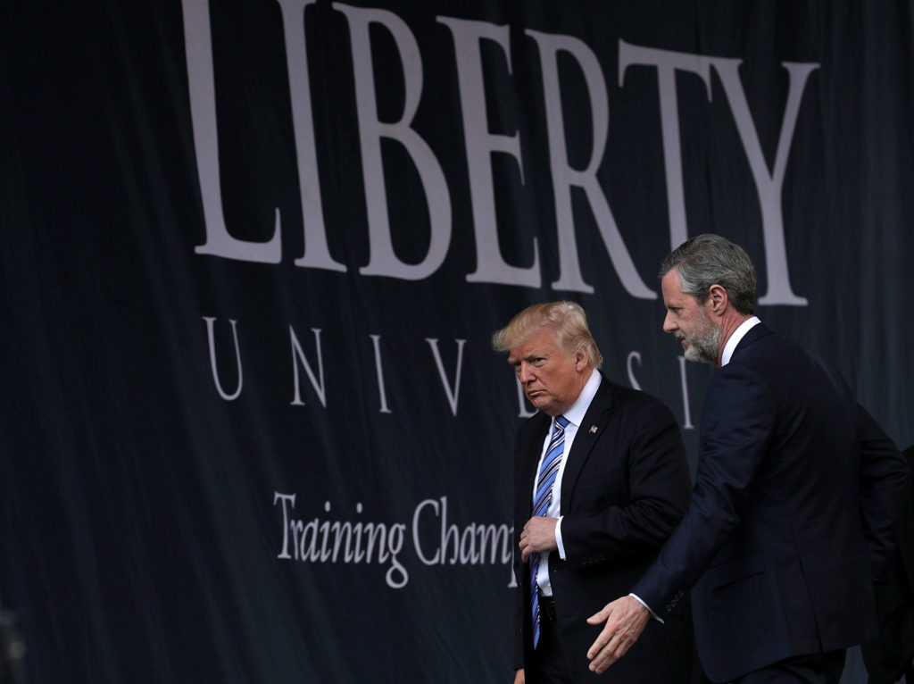 Accompanied by Jerry Falwell, Donald Trump leaves after he delivered keynote address during the commencement at Liberty University in 2017