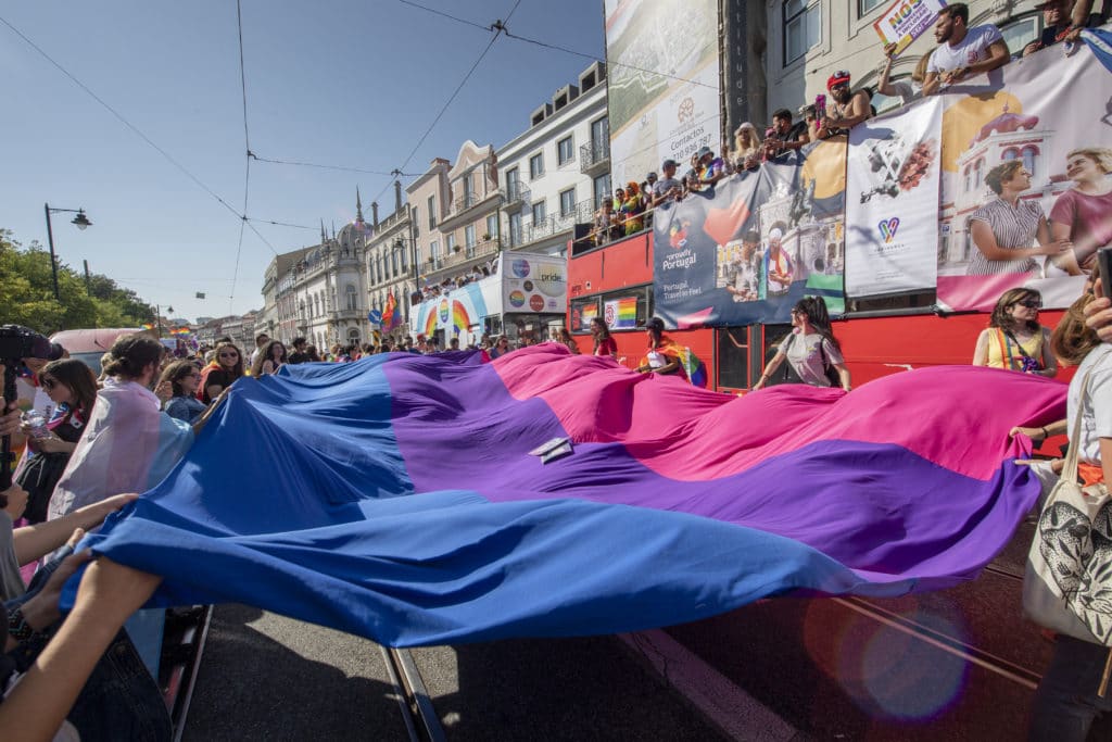 Participants display a bisexual pride flag during a 2019 pride parade in Lisbon, Portugal