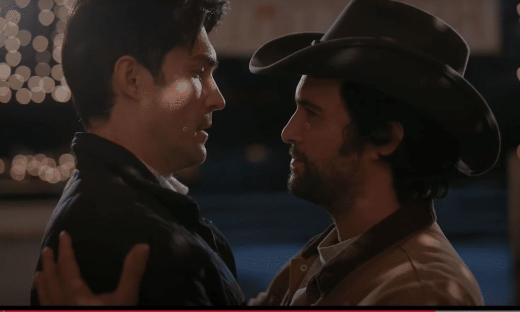 Two men embracing, one wearing a cowboy hat, in the Dashing in December trailer
