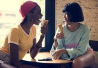 Two women eating ice cream cones