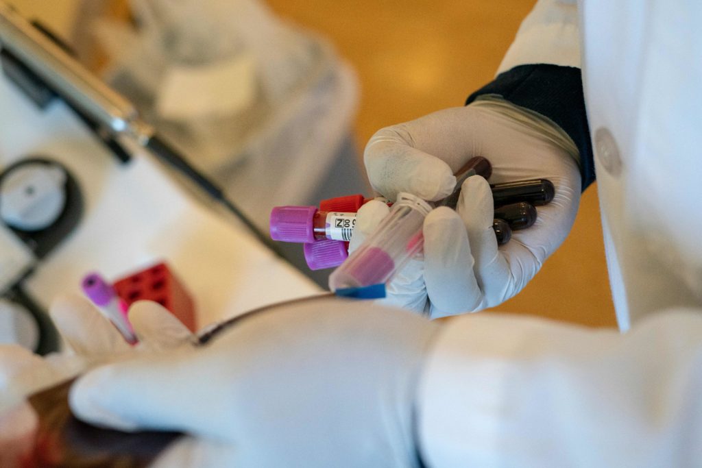 A phlebotomist takes blood donation samples