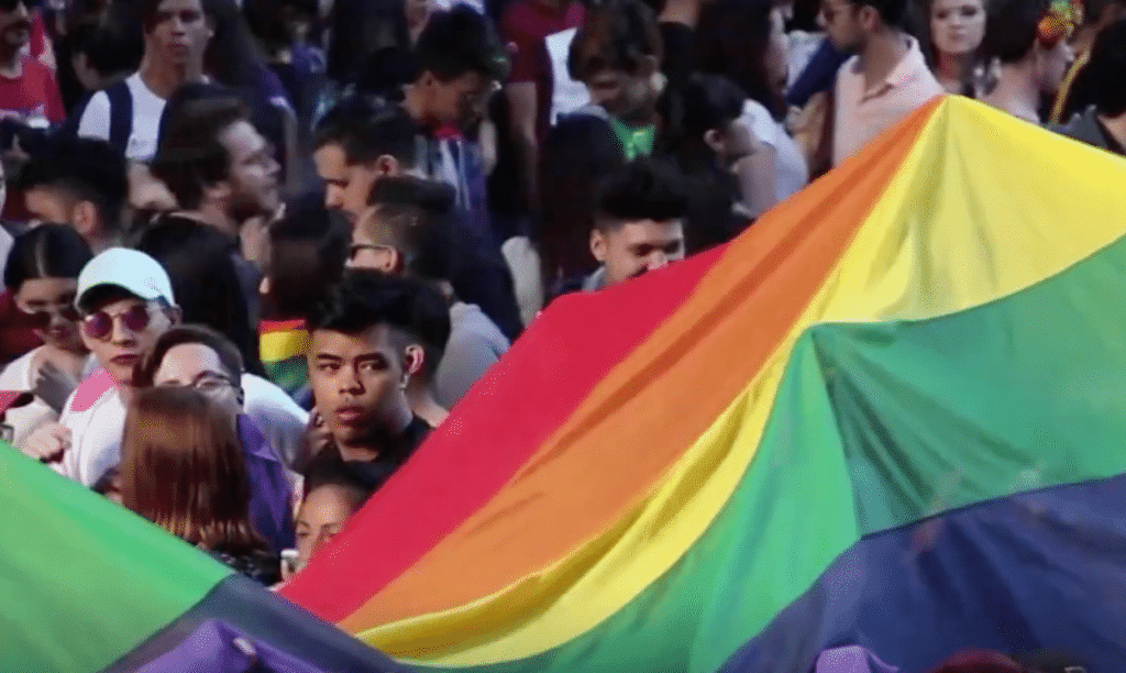 Protesters holding a giant Pride banner