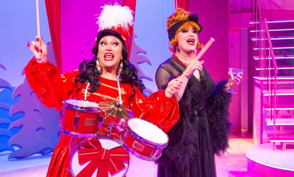 BenDeLaCreme dressed as a drummer with Jinkx Monsoon in a feather-trimmed nightgown