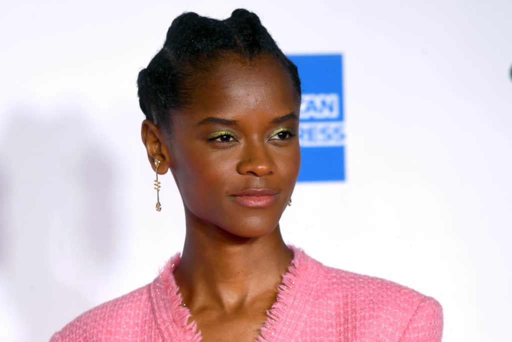 Letitia Wright in a pink suit jacket