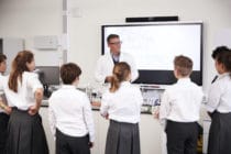 Teacher addressing students in a high school
