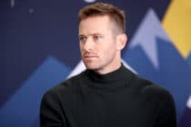 Armie Hammer in a black turtleneck looking to the right