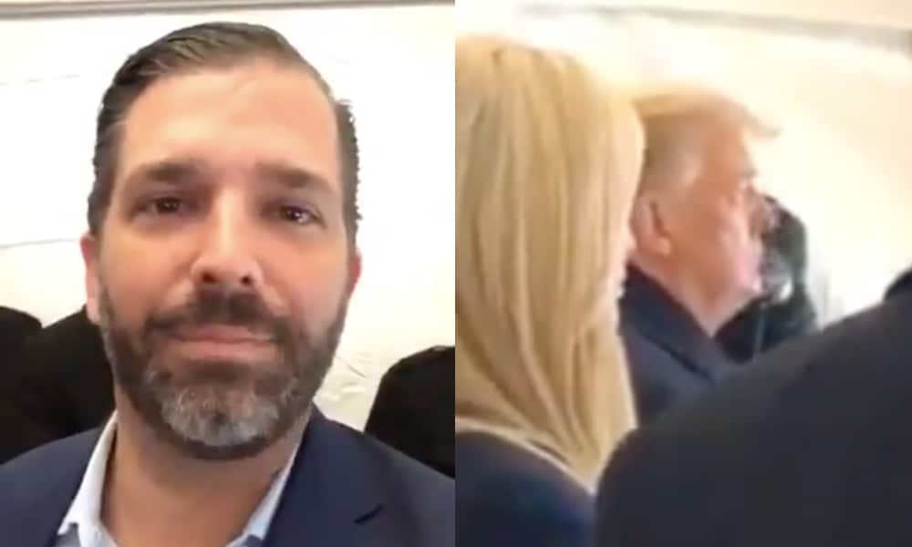 Donald Trump Jr smiles to the camera as his father watches footage of his supporters at a rally