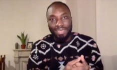 Ignatius Annor speaks in his home wearing a patterned jumper