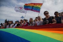 Members of the Alliance of Heterosexuals and LGBT for Equality, their flag on the left, at the St Petersburg LGBT+ Pride
