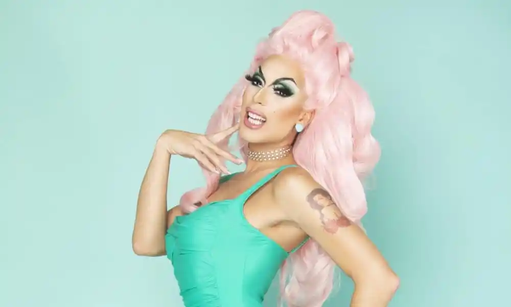 Alaska, a drag queen in pink hair and a green dress