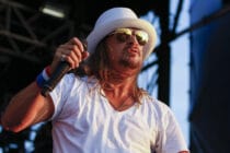 Kid Rock performs in a white v-neck and white fedora